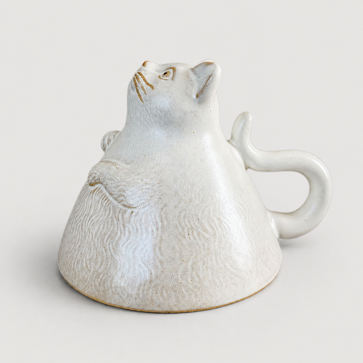 Ivory cat ceramic cup: inverted animal display