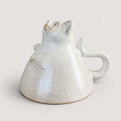 Ivory cat ceramic cup: inverted animal display